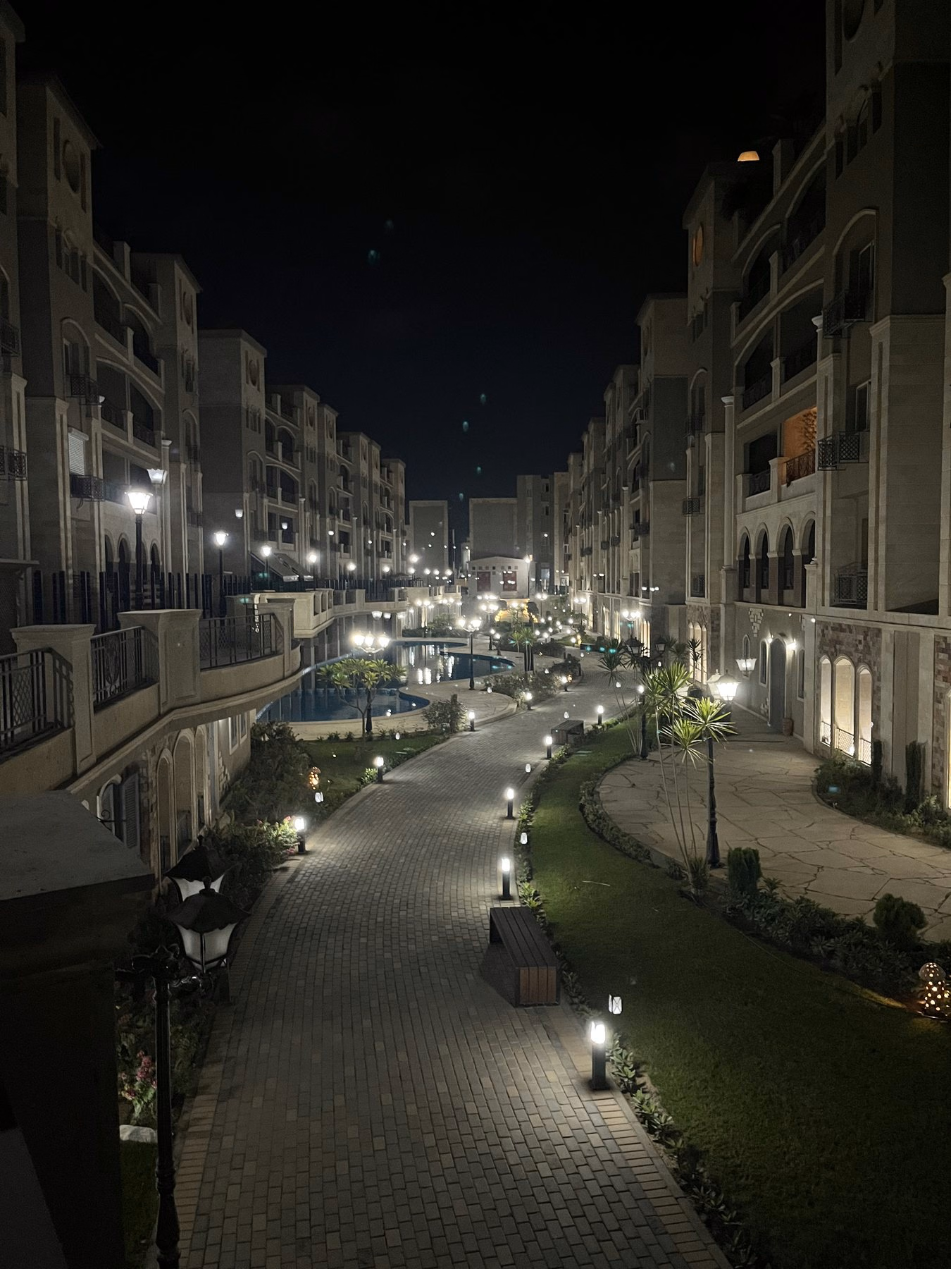 Walkway and apartment buildings in Rock Vera Compound at night